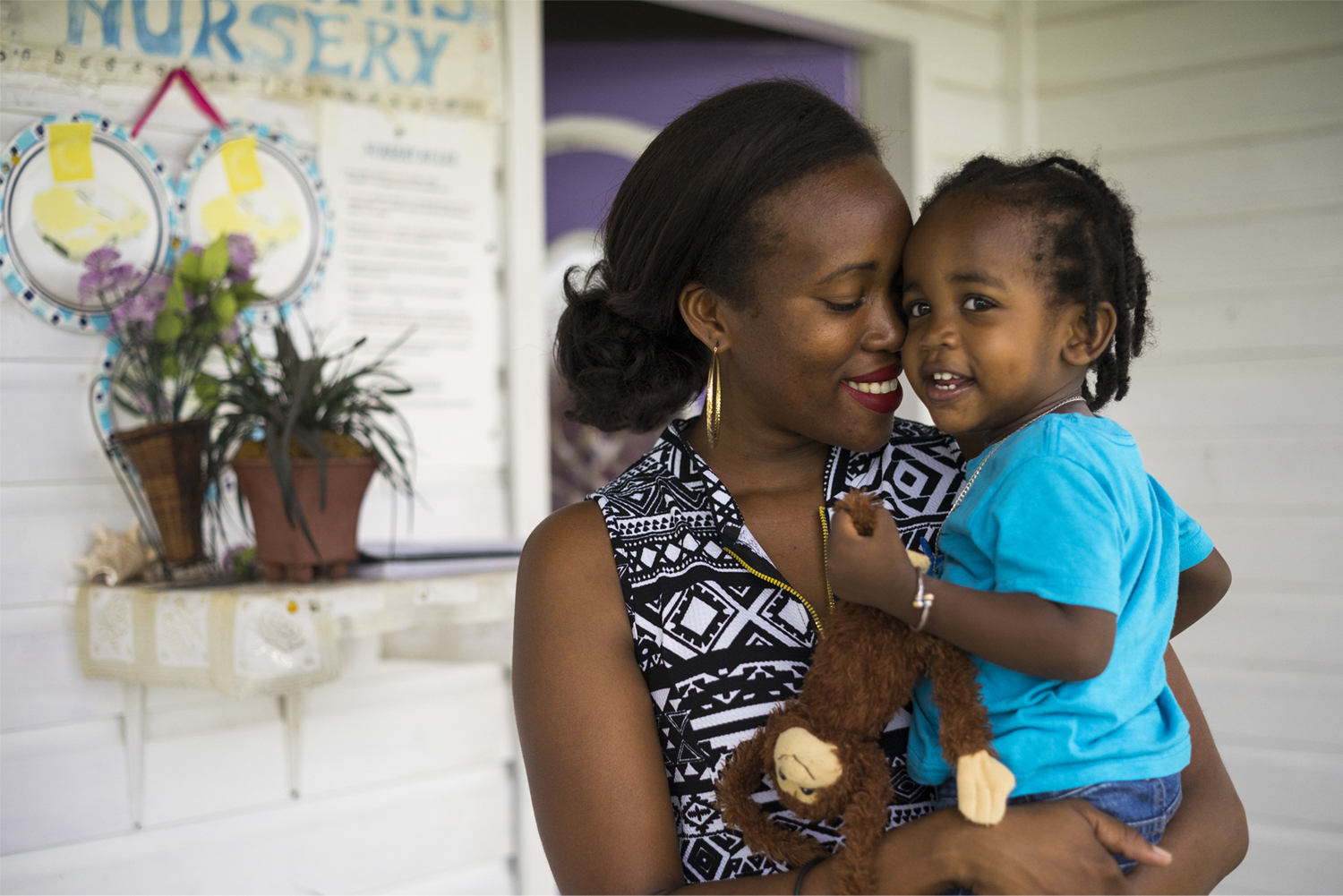 A child and her mother smile in St. Kitts and Nevis.